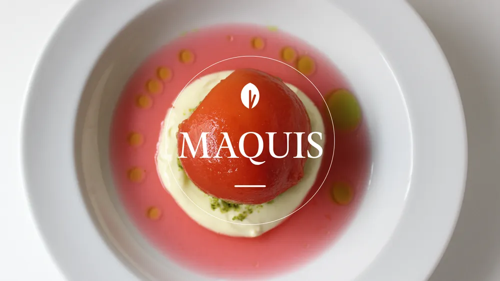 A tomato dish with sauce in a white bowl, labeled 'MAQUIS'.