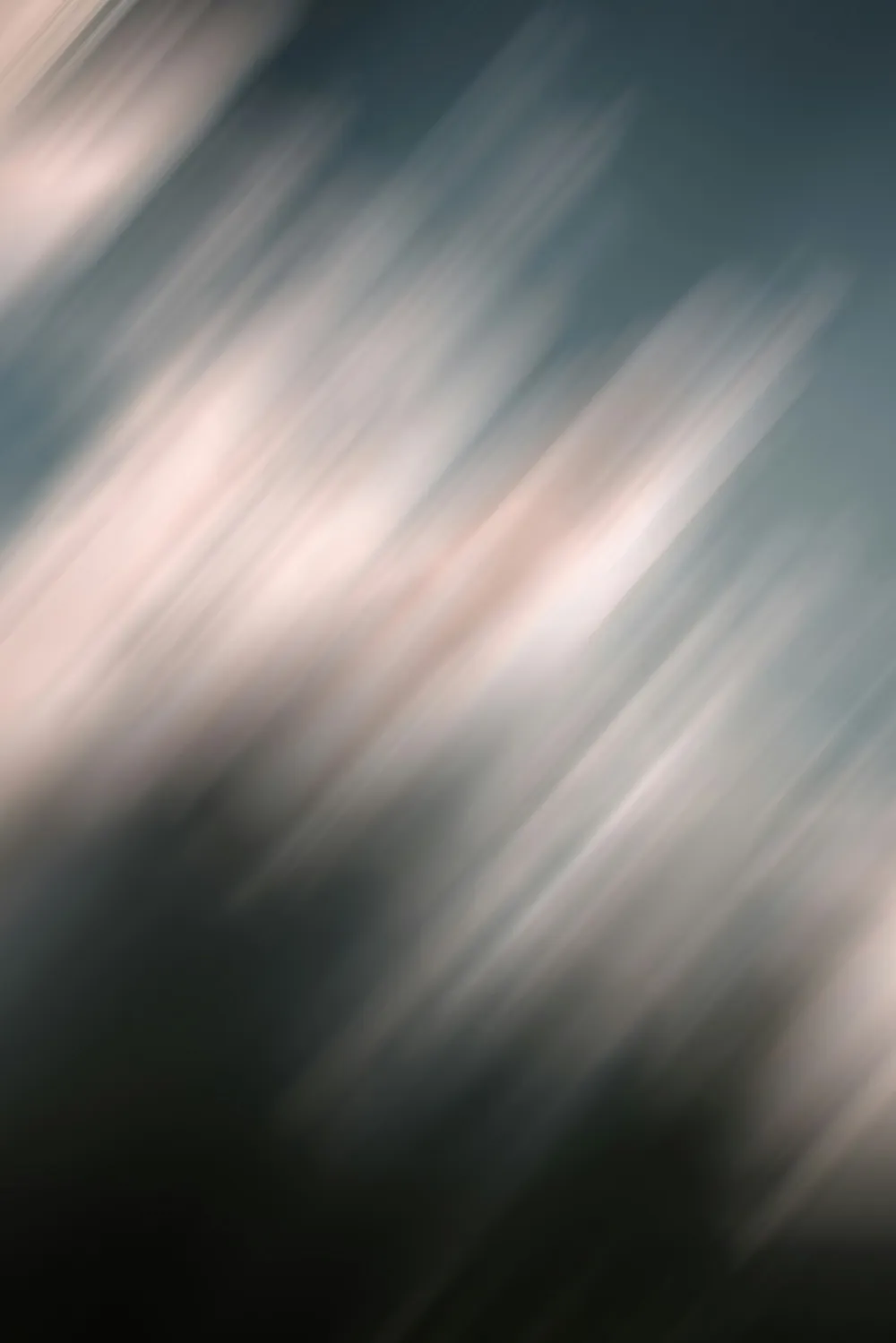 Abstract blurred light streaks on a dark background.