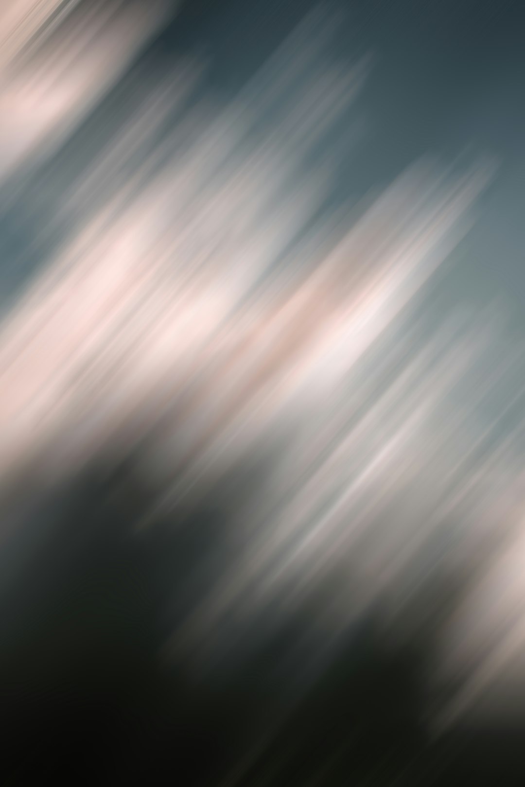 Abstract blurred light streaks on a dark background.