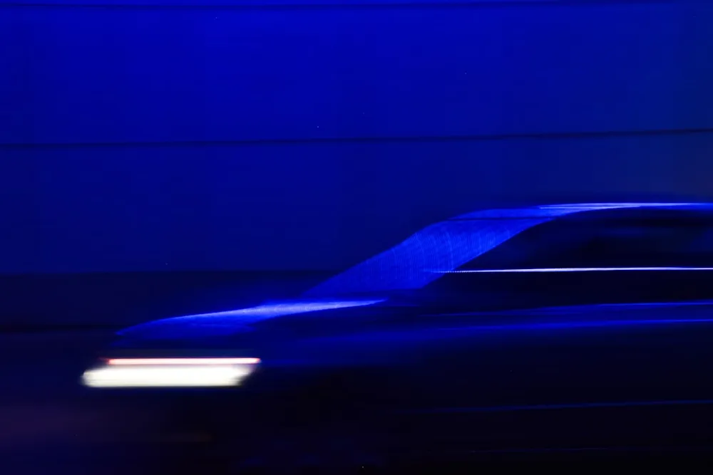 Blurred car in motion with blue lighting.