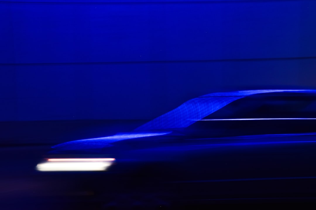Blurred car in motion with blue lighting.