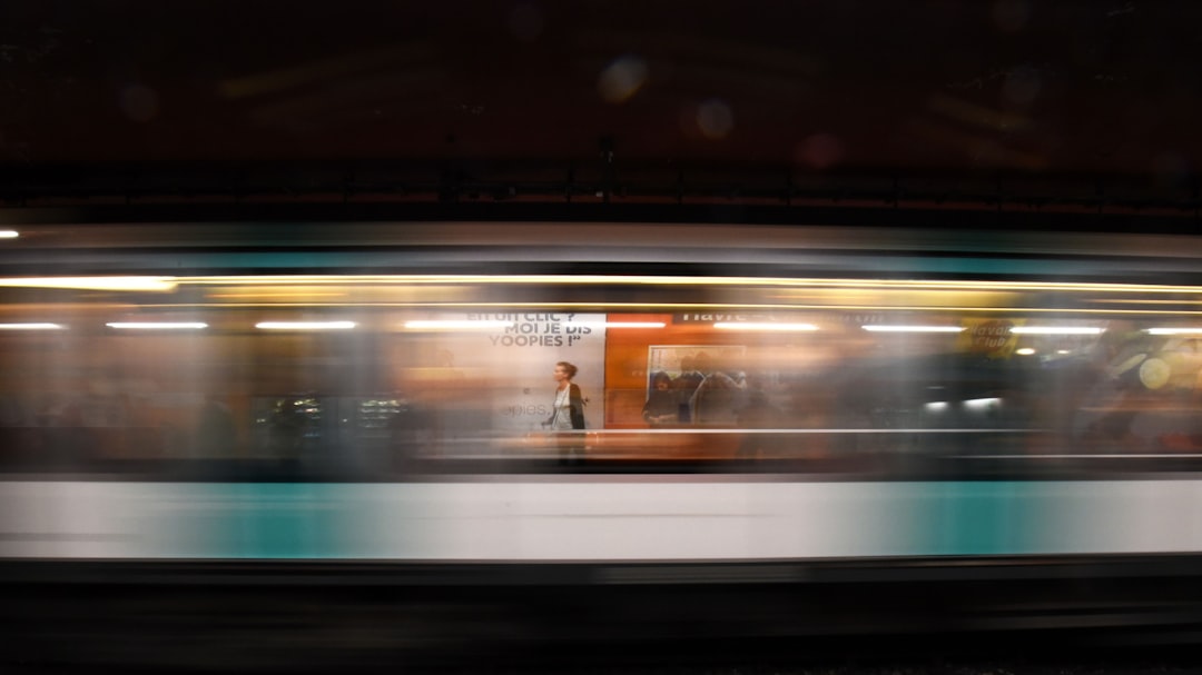 Blurred motion of a subway train passing by a station.