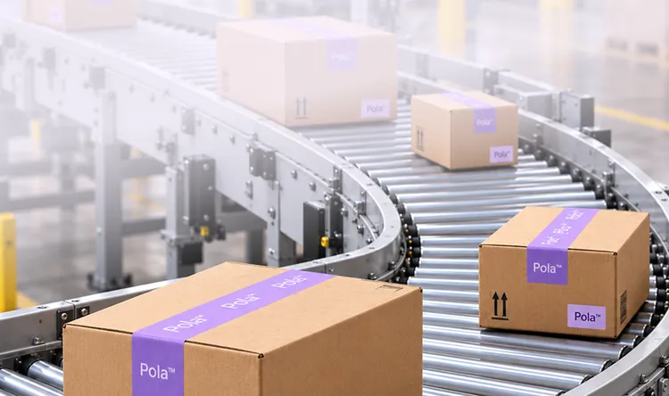 Cardboard boxes with 'Pola' branding on a conveyor belt in a warehouse.