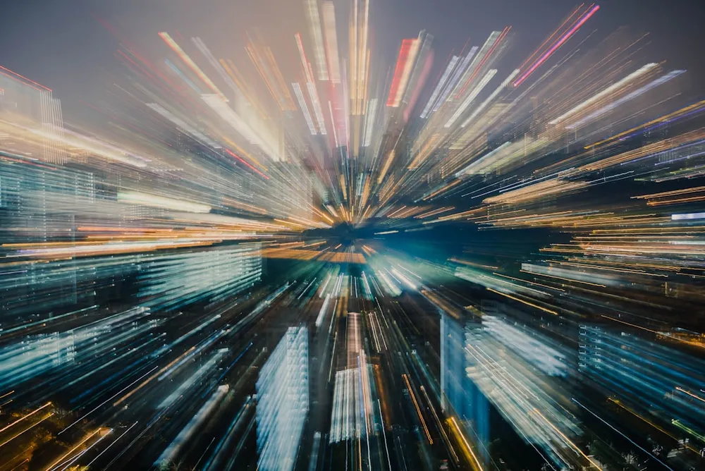 Cityscape with light trails creating a zoom effect.