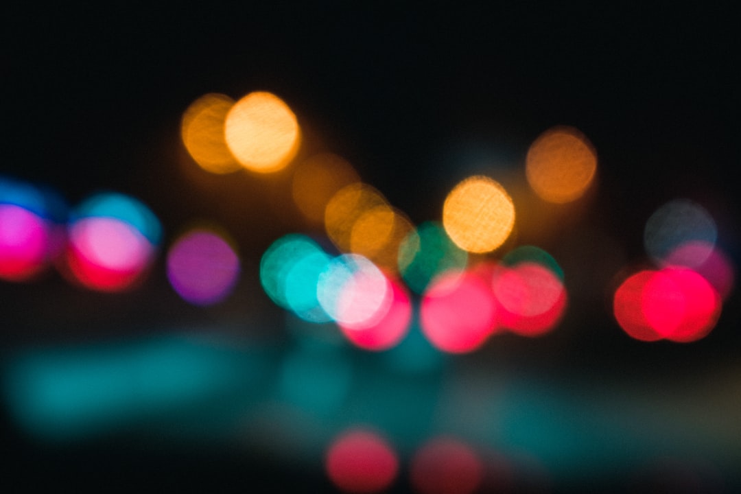 Colorful bokeh lights against a dark background.