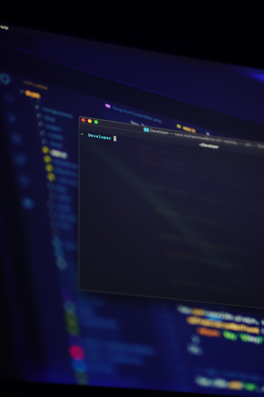 Computer screen displaying a code editor with a terminal window open.