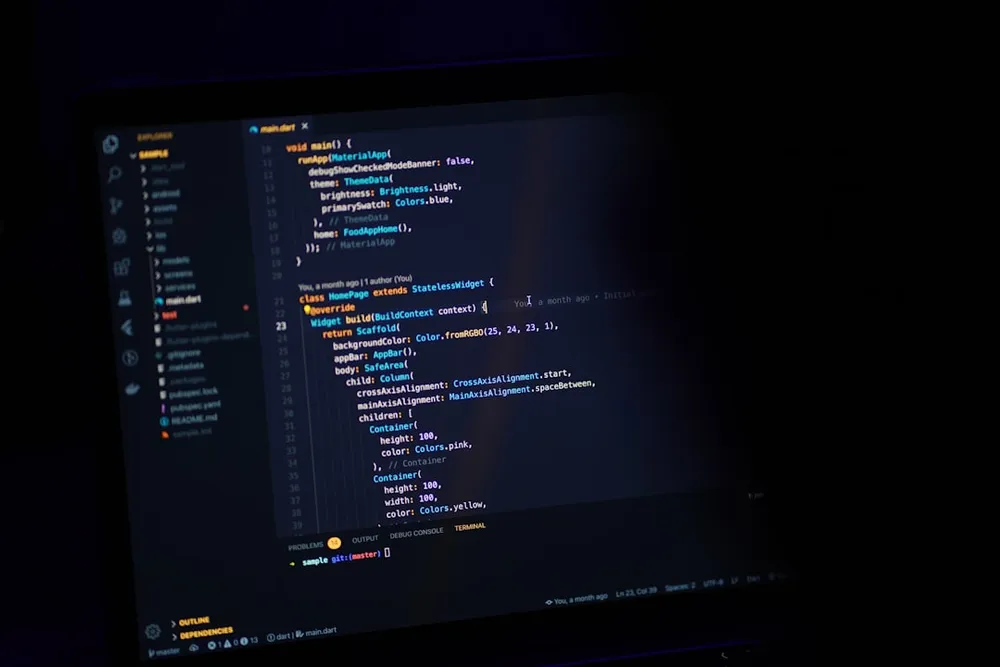 Écran d'ordinateur affichant du code dans un environnement sombre.
