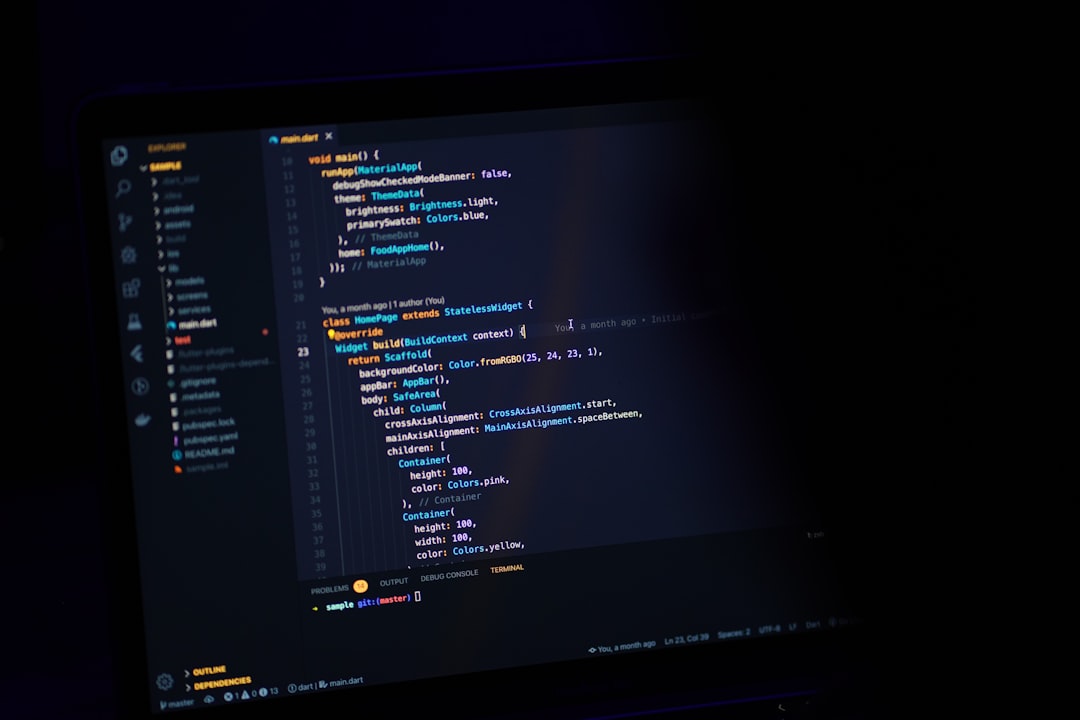 Computer screen displaying code in a dark environment.