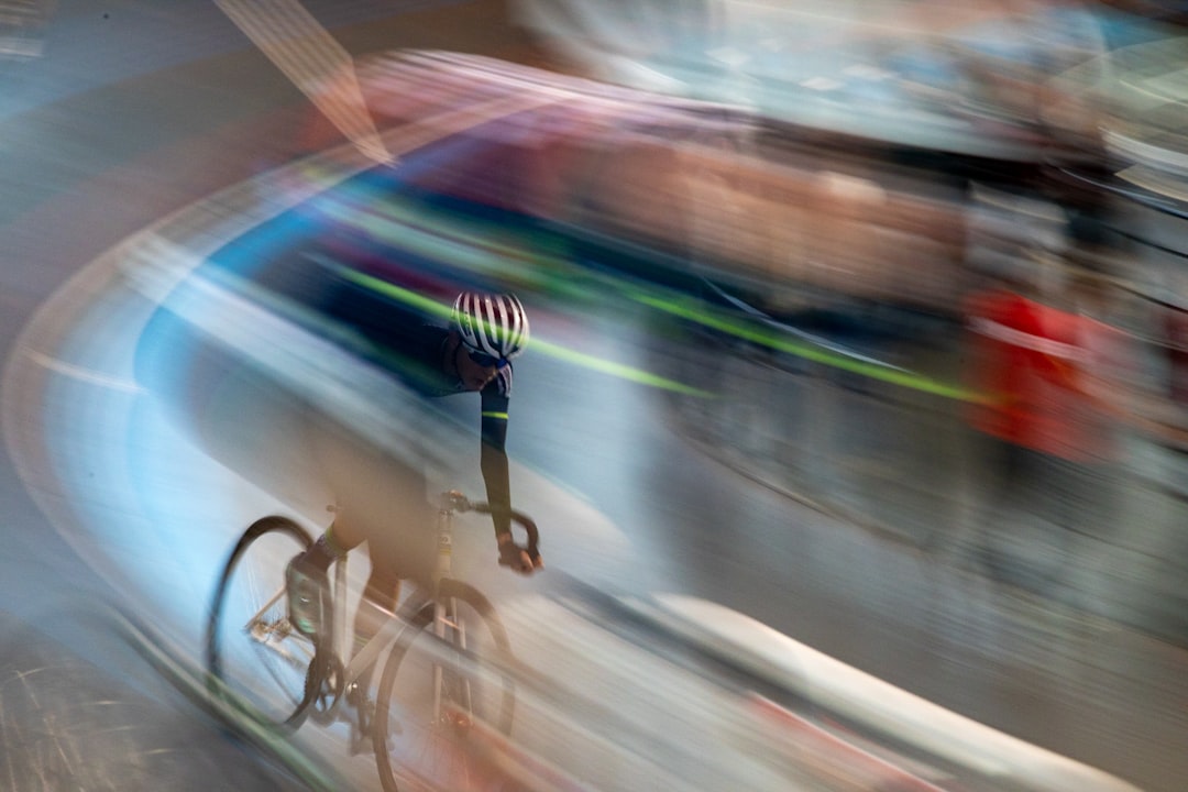 Cyclist racing on a track with motion blur.