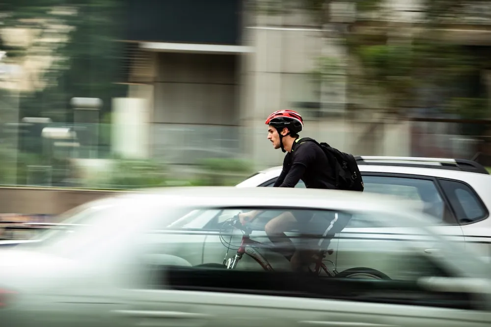 Cyclist riding through city traffic.