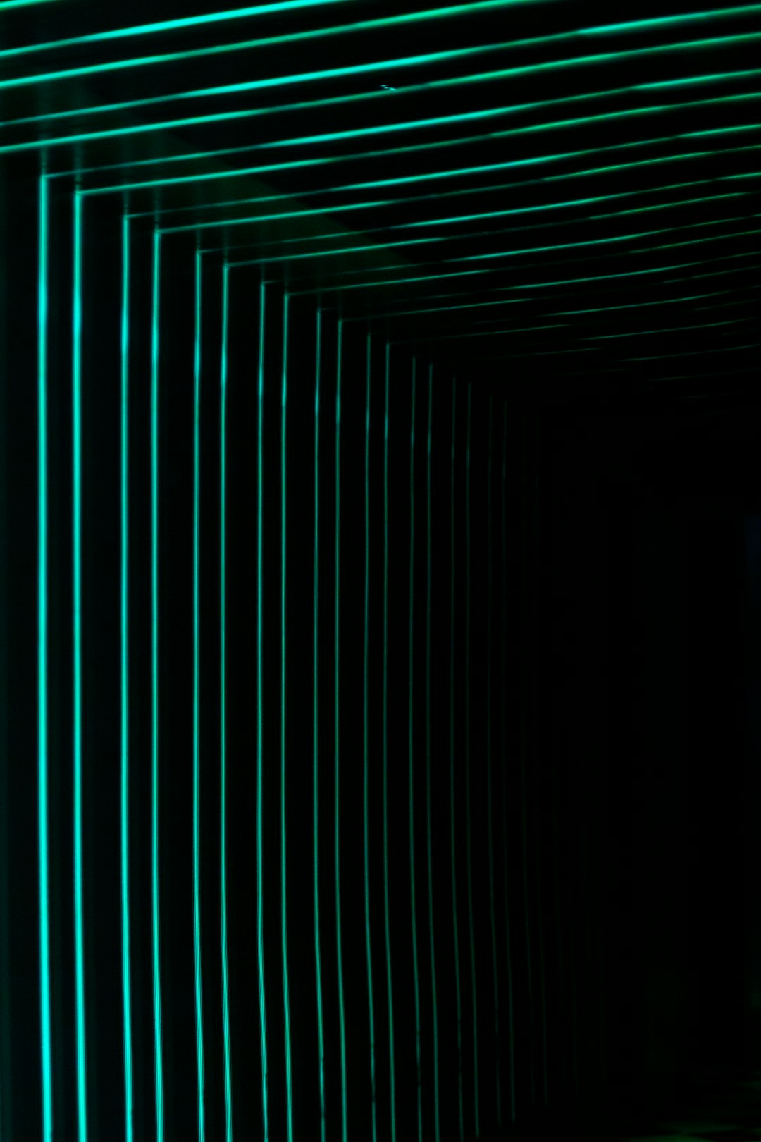 Dark corridor with glowing green lines on the walls and ceiling.