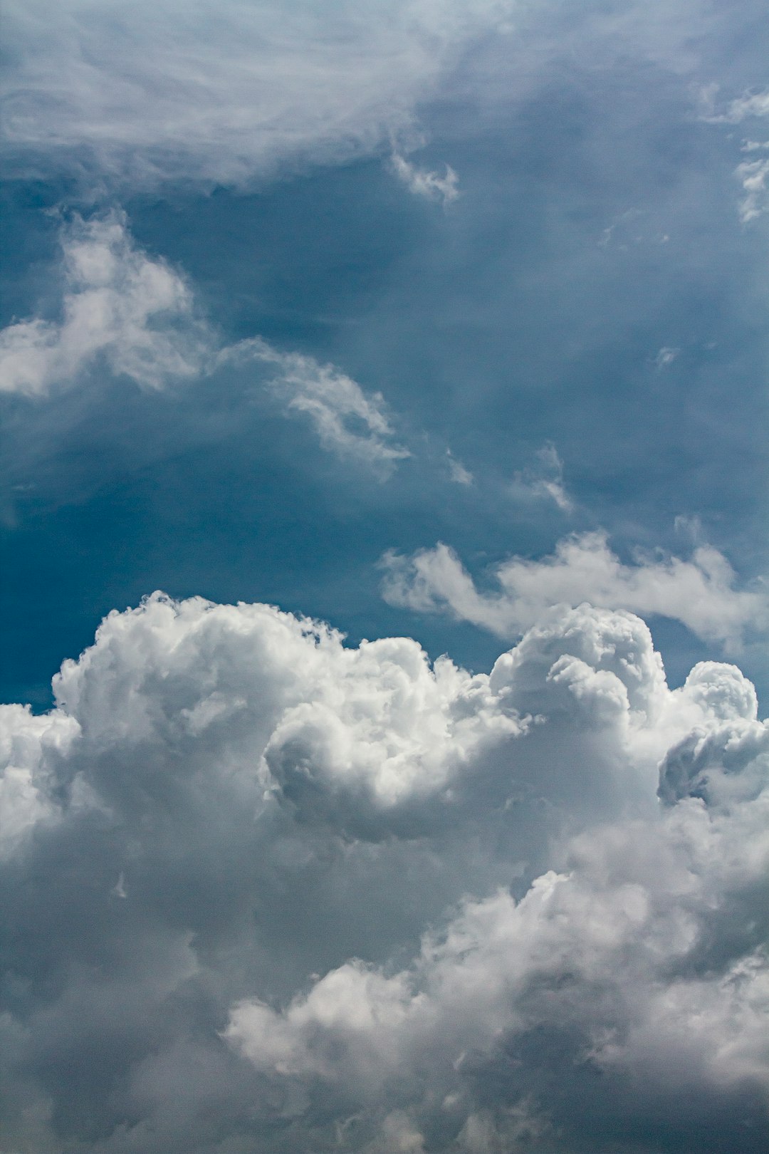 Fluffy white clouds against a blue sky.