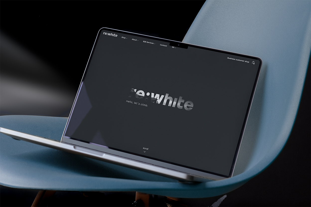 Laptop displaying a website on a blue chair.