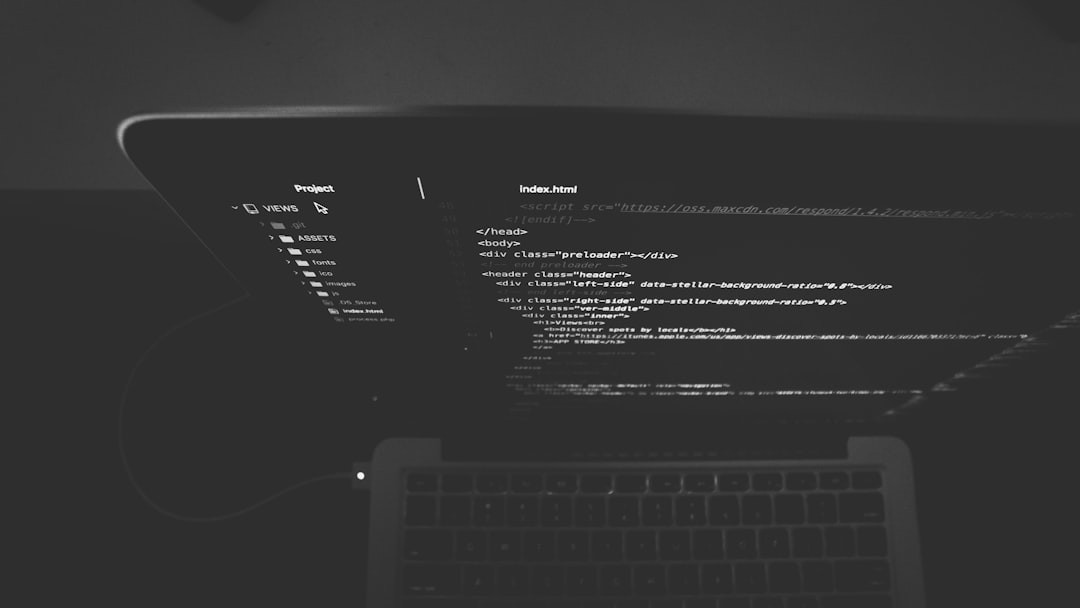 Laptop screen displaying HTML code in a dark setting.