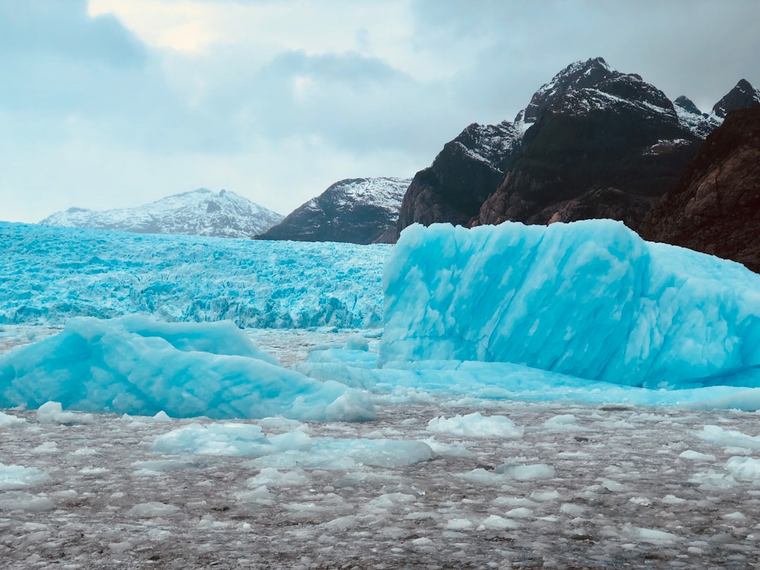 Large blue glacier with mountains in the background.