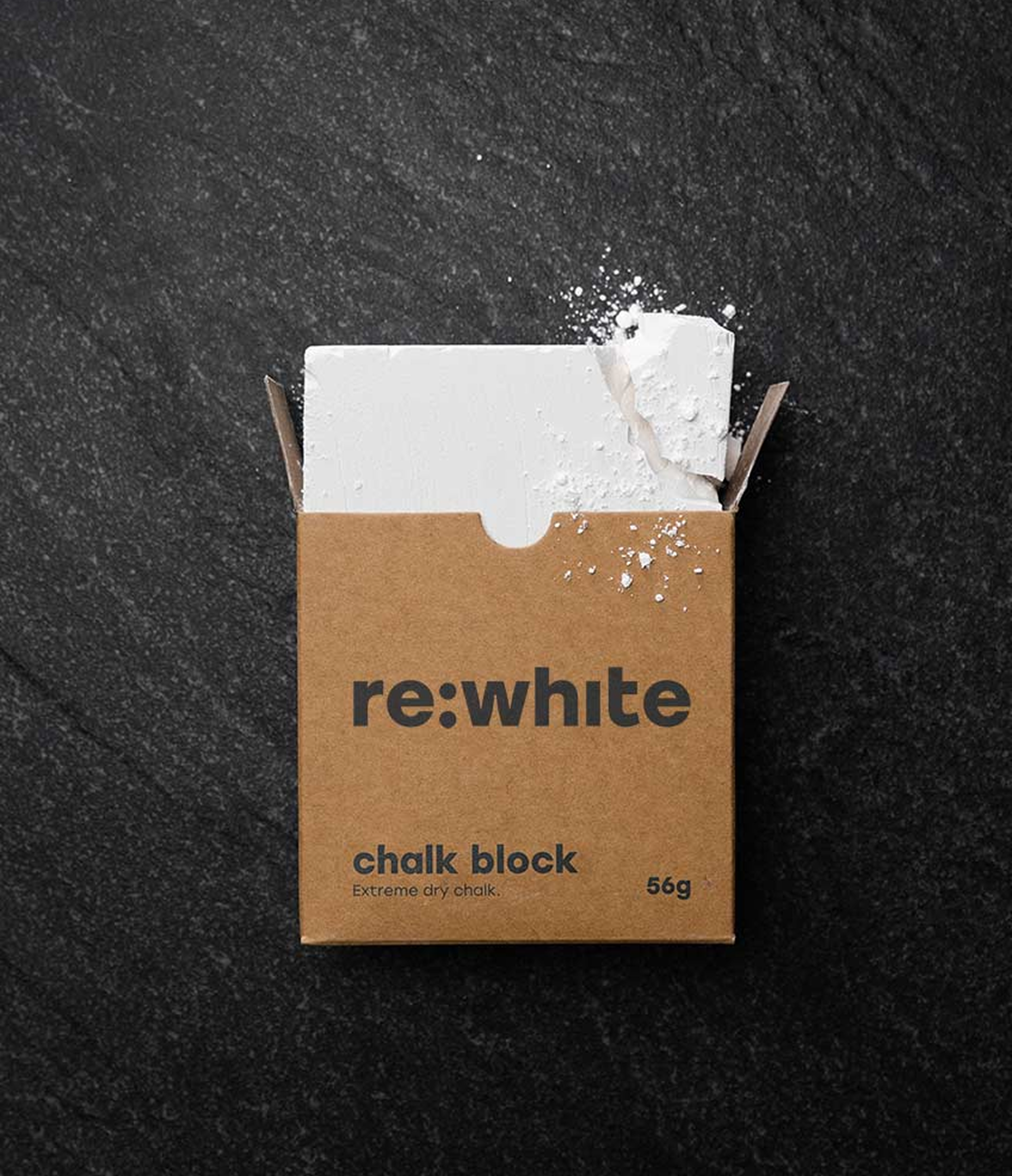 Open box of re:white chalk block on a dark surface.