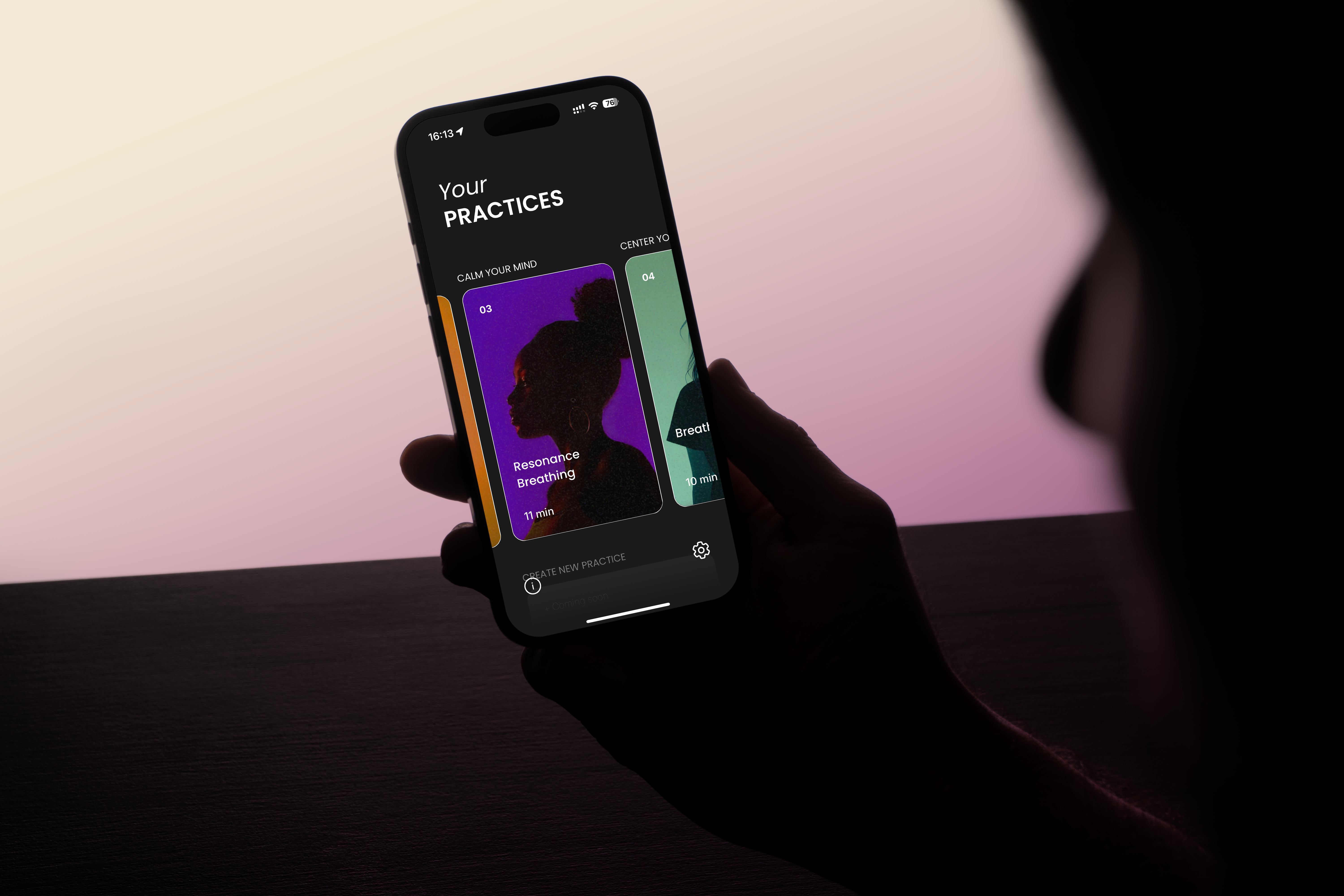 Person holding a smartphone displaying a meditation app interface.
