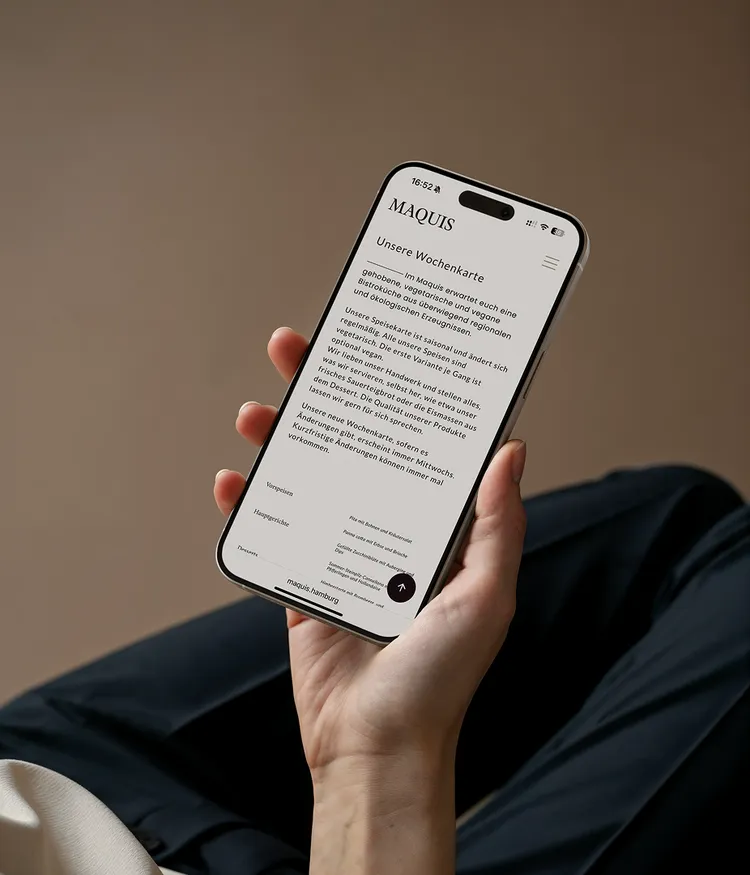 Person holding a smartphone displaying a menu.