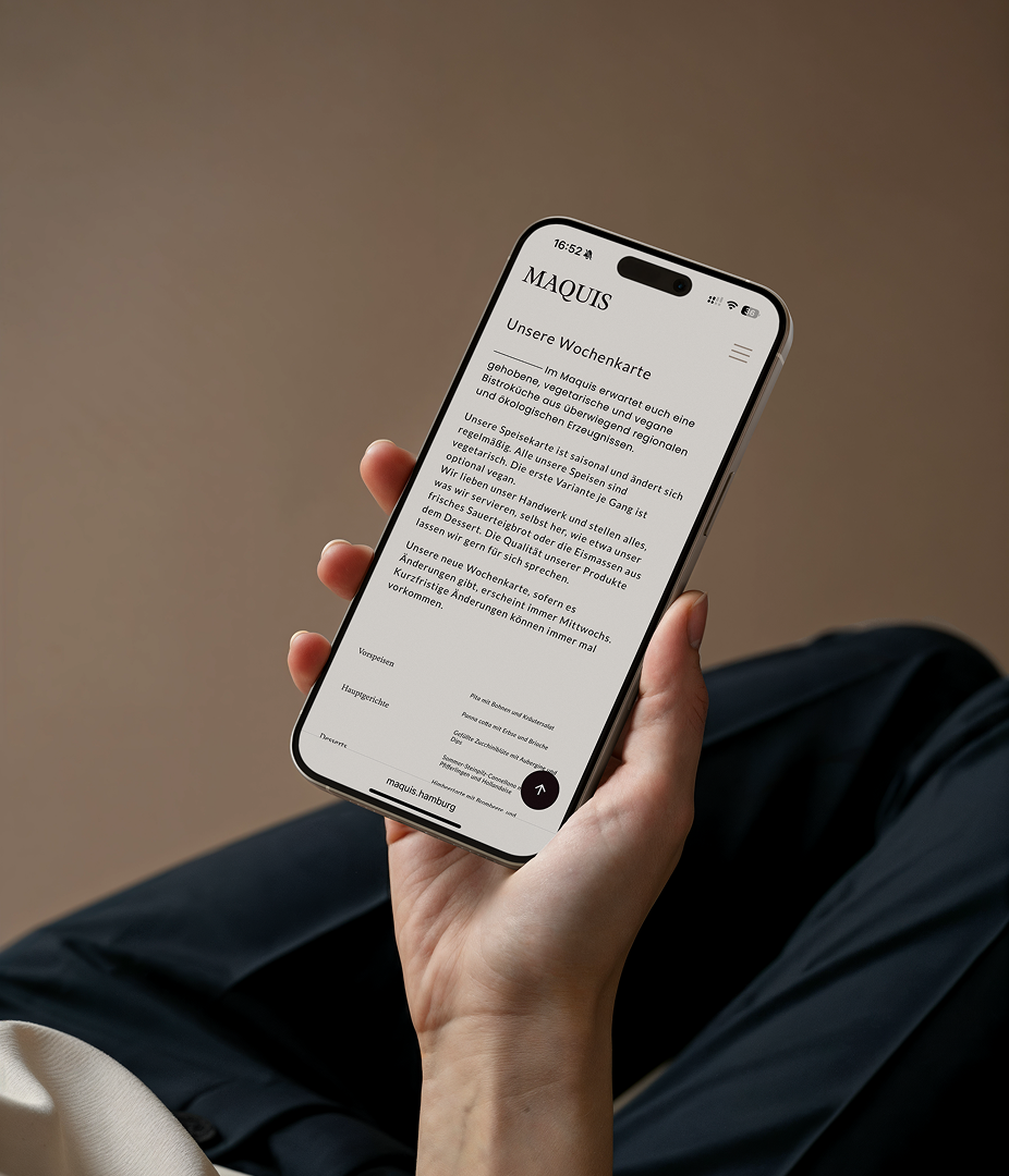 Person holding a smartphone displaying a menu.