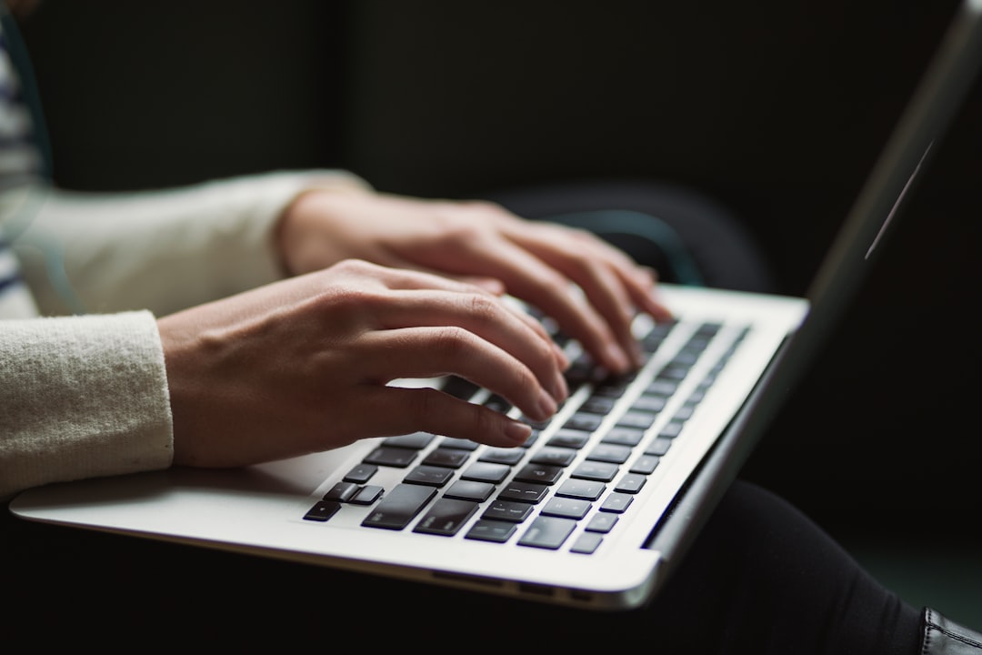 Person typing on a laptop keyboard.