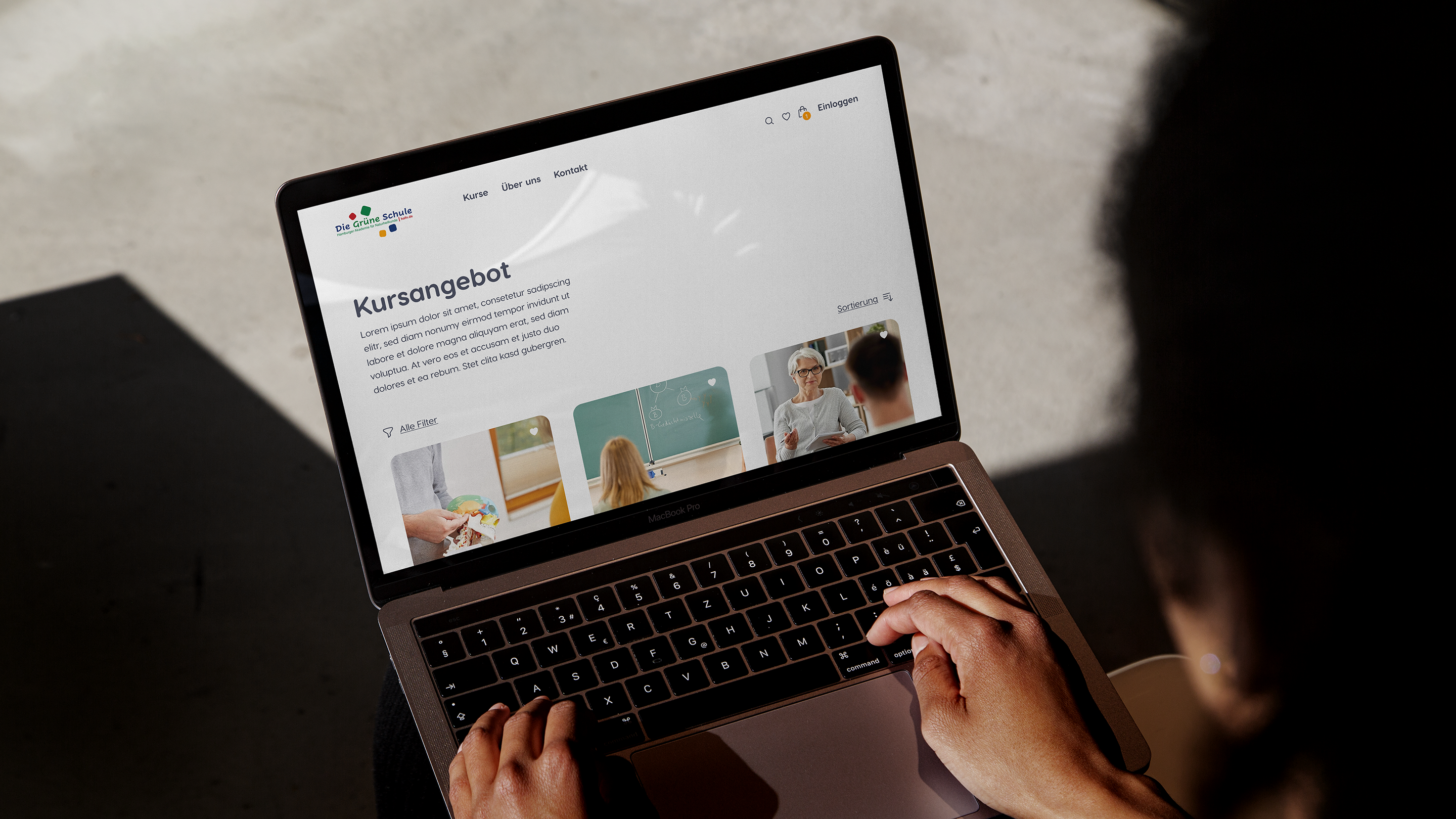 Person using a laptop displaying a website with educational content.