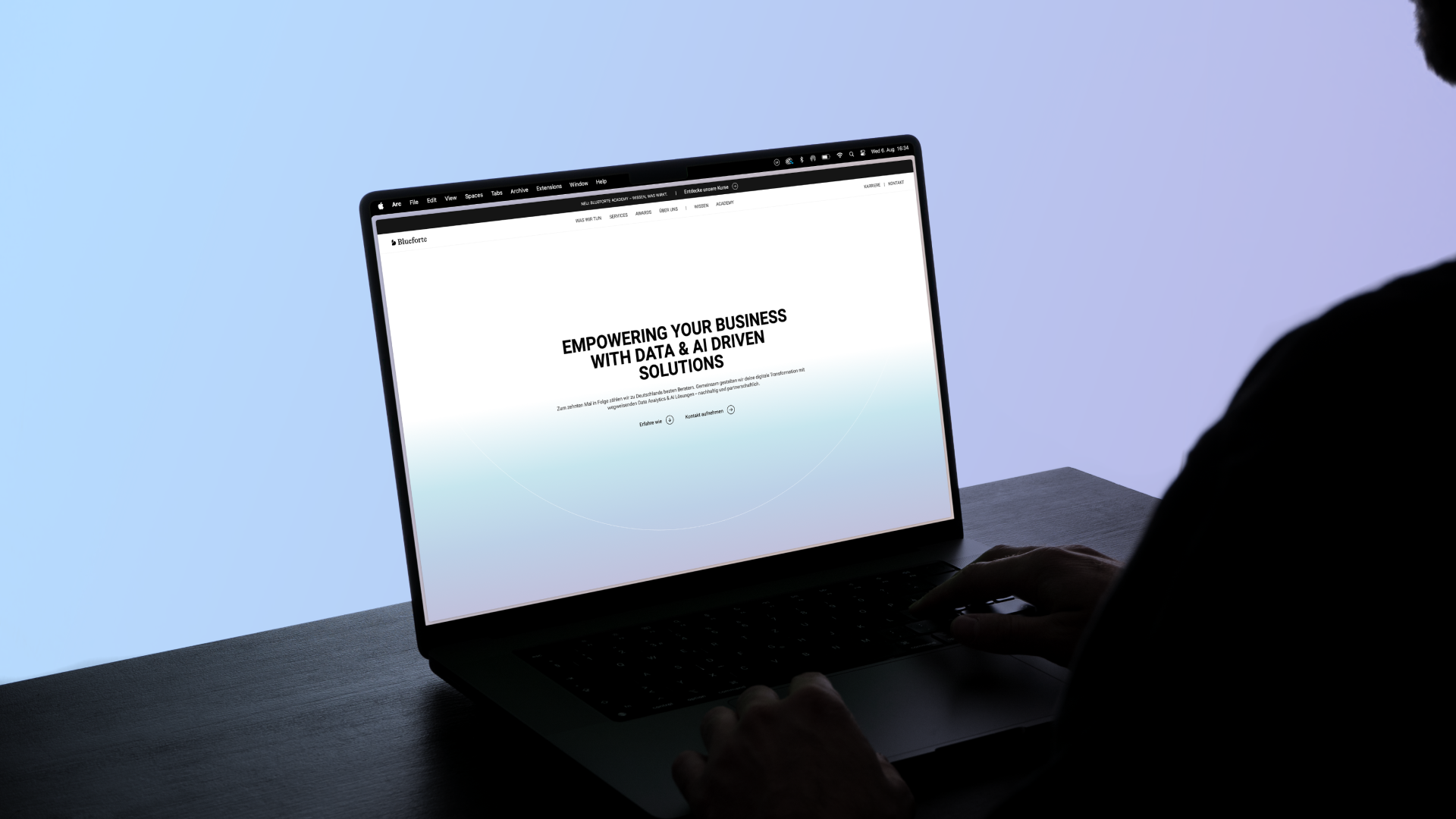 Person using a laptop with a business website on the screen.