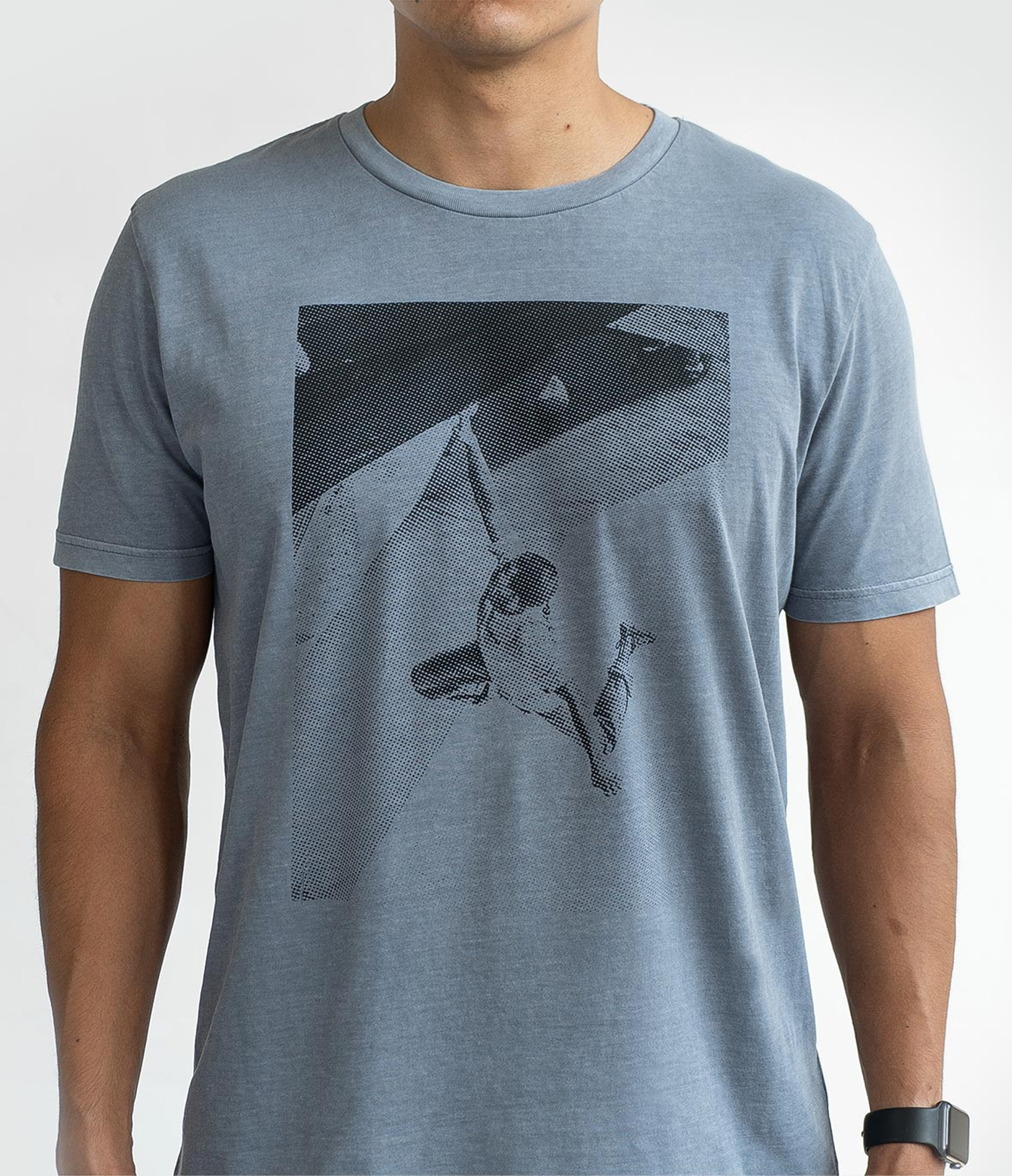 Person wearing a blue t-shirt with a graphic print.