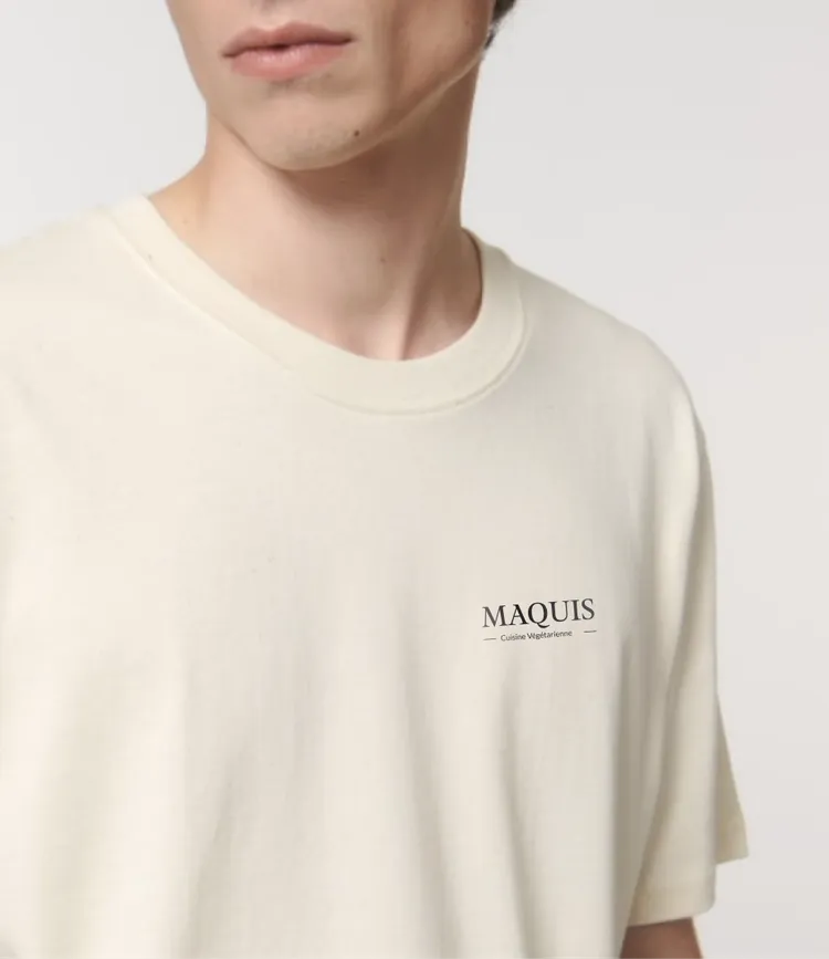 Person wearing a cream-colored t-shirt with 'MAQUIS' text.
