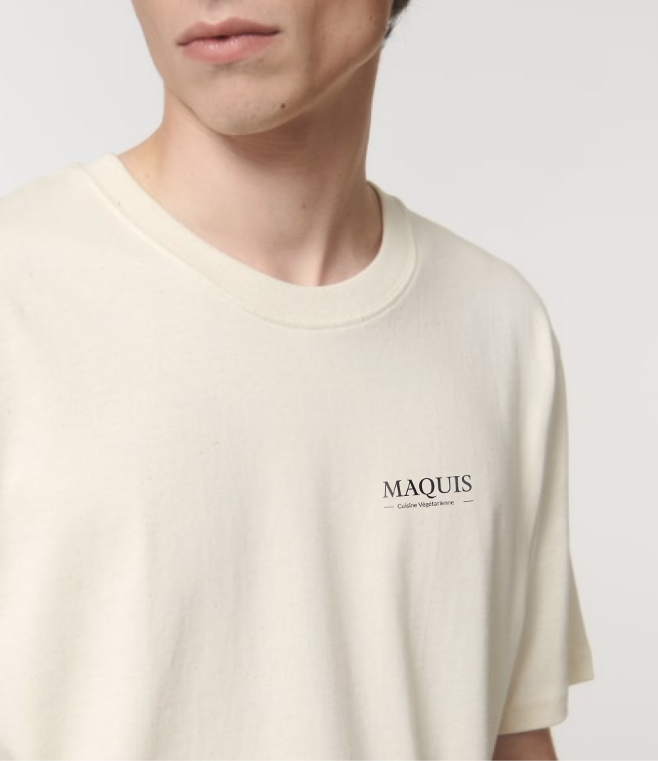 Person wearing a cream-colored t-shirt with 'MAQUIS' text.