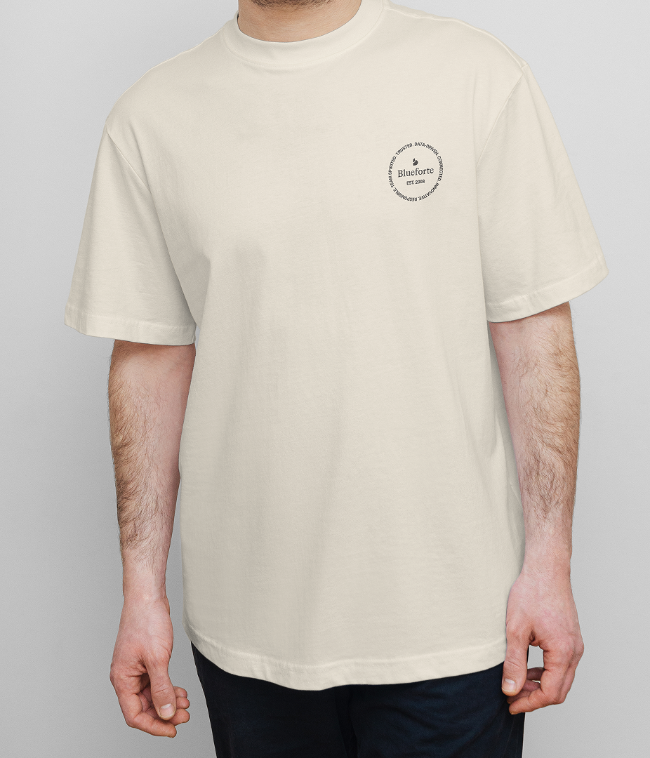 Person wearing a plain white t-shirt with a small logo.