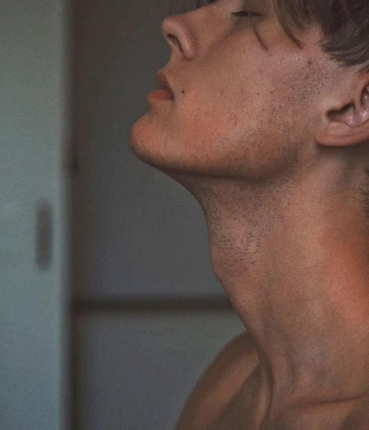 Person with head tilted back in profile view.