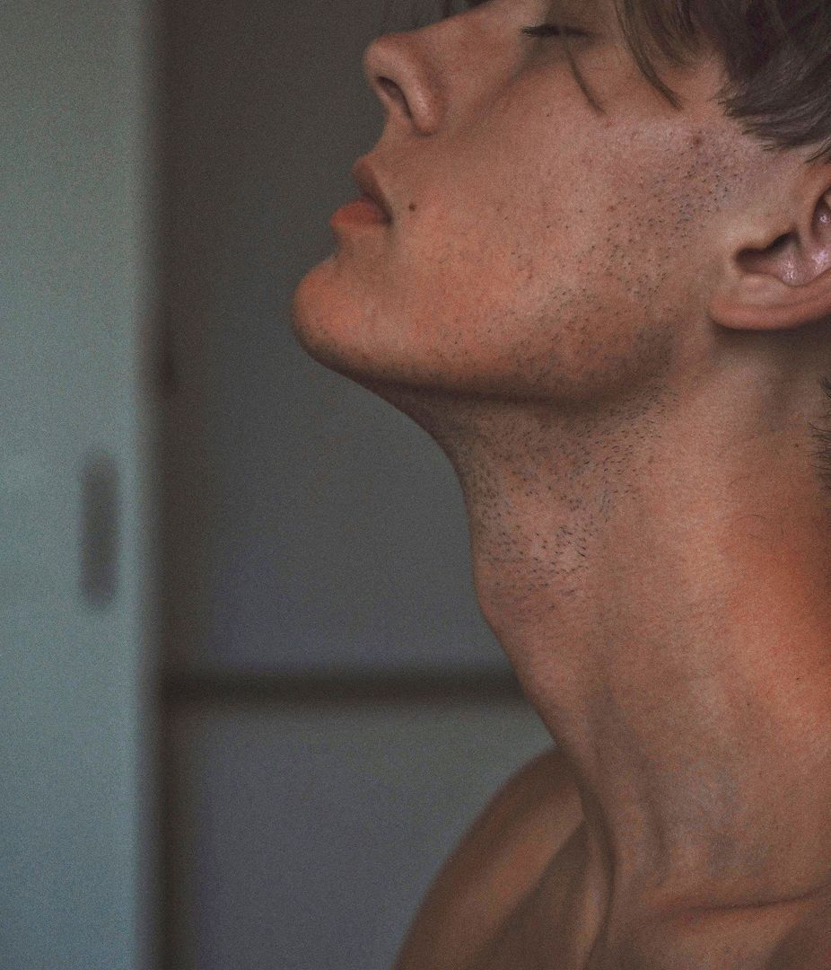 Person with head tilted back in profile view.