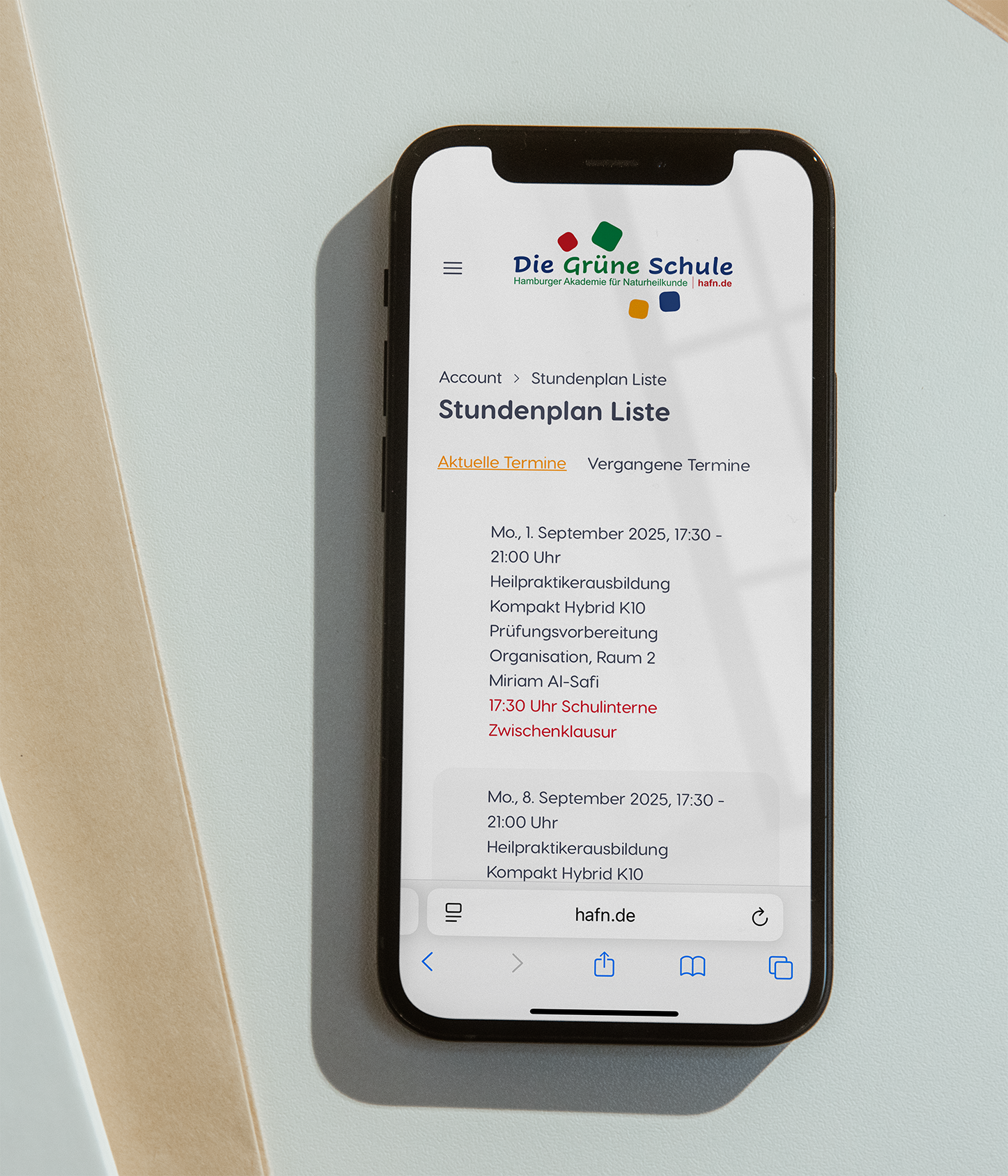 Smartphone displaying a schedule list on a website.
