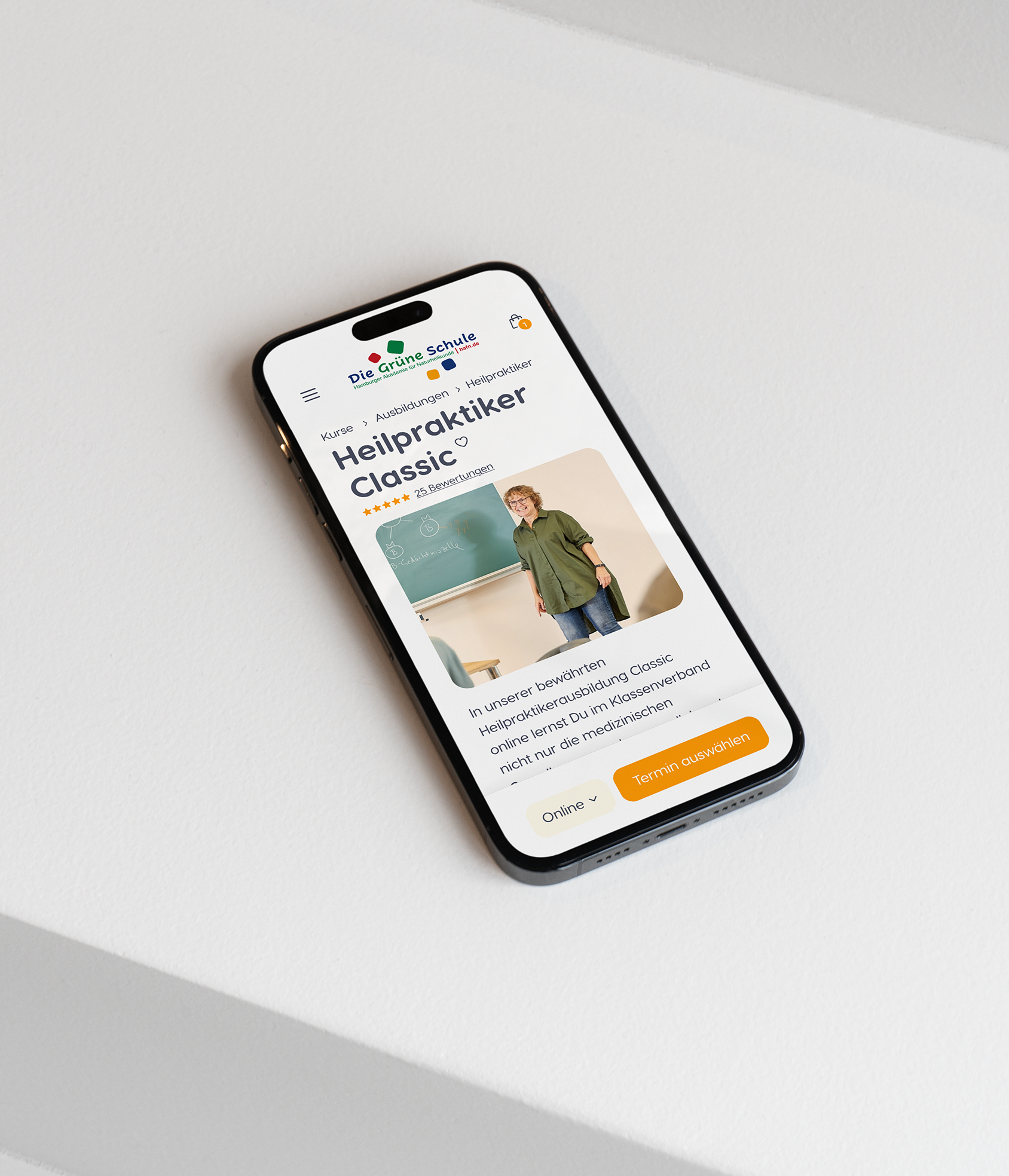 Smartphone displaying a website on a white surface.
