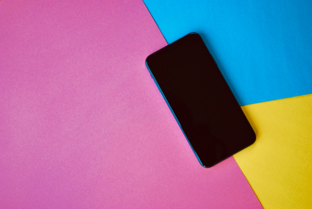 Smartphone on colorful paper background.