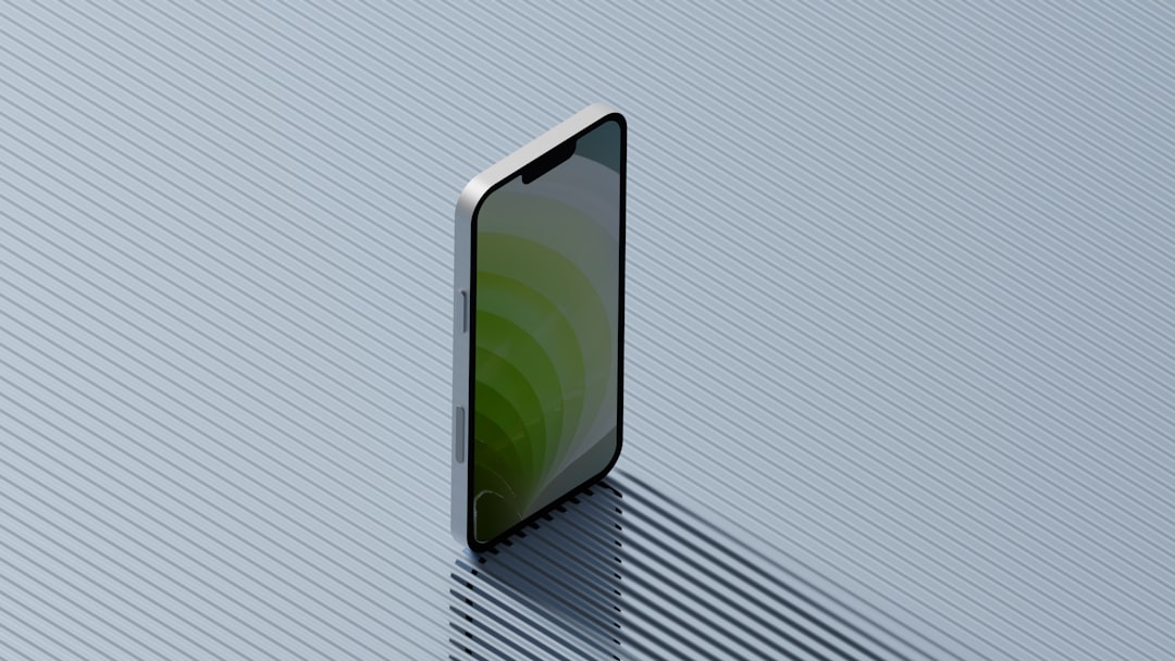 Smartphone standing on a textured surface casting a shadow.