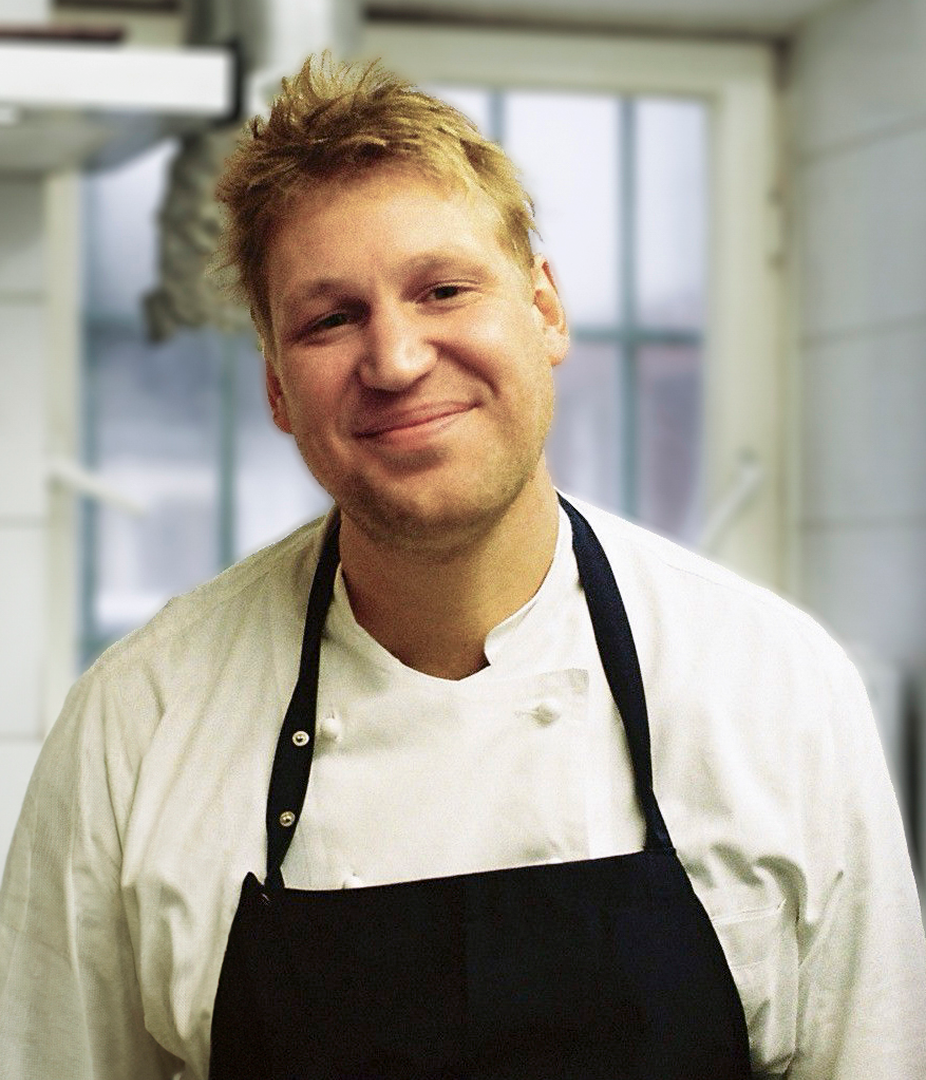 Smiling chef in a kitchen.