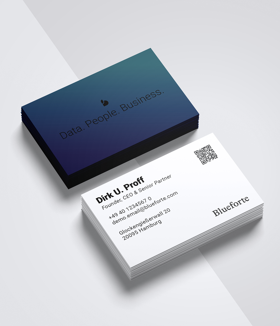Stack of business cards with one showing contact details.