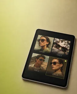 Tablet displaying four images of sunglasses and models in a grid layout, on a green surface. The images include two models wearing sunglasses and two sets of sunglasses alone, each labeled 'VALE'.